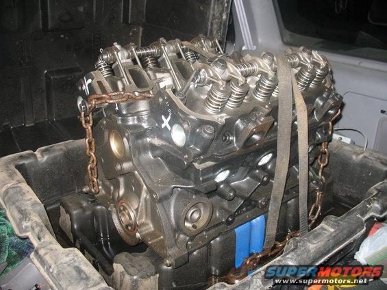 Engine block secured with chains and straps inside a container