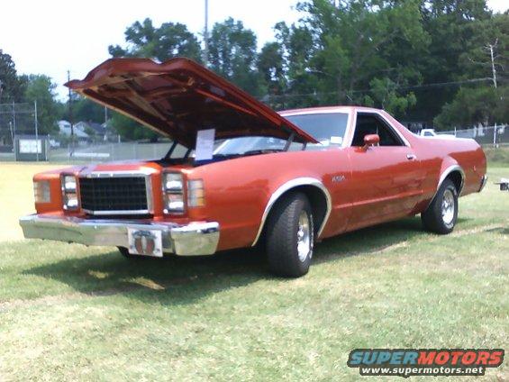 Orange 1979 Ford Ranchero with hood open, parked on grass