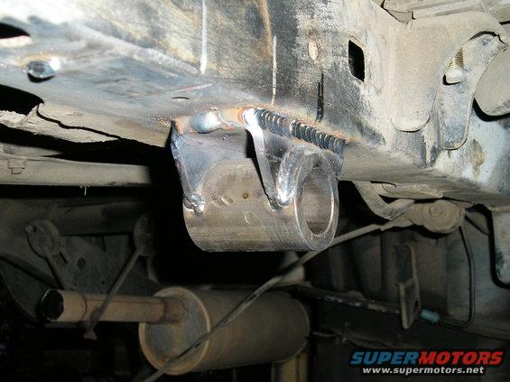 Custom suspension mount welded to frame, exhaust visible below