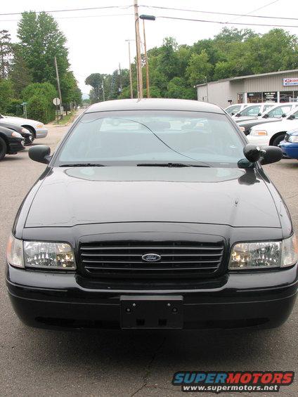 Black 2000 Ford Crown Victoria front view, parked on asphalt, with a cracked windshield