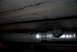1994 Dodge Stealth - Underside view of a vehicle's exhaust system, showing a pipe and hanger assembly.