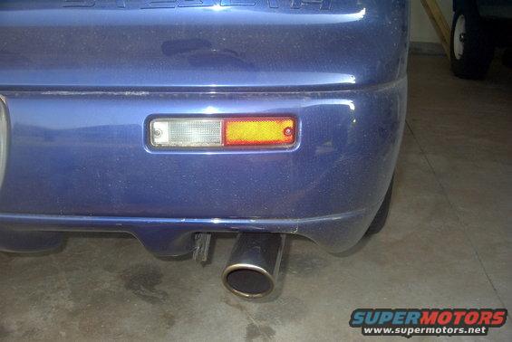 Blue 1994 Dodge Stealth rear bumper with exhaust pipe and reflector light