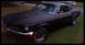 1968 Ford Mustang - A matte black 1968 Ford Mustang is shown from a three-quarter front view, parked on a grassy lawn.