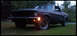 1968 Ford Mustang - A matte black 1967 Ford Mustang coupe is shown from a three-quarter front angle, parked on a grassy lawn.
