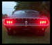 1968 Ford Mustang - Rear view of a 1968 Ford Mustang, its distinctive taillights and the prominent "MUSTANG" script across the trunk lid.