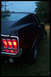 1968 Ford Mustang - Rear view of a 1968 Ford Mustang, showing its distinctive triple taillights and chrome bumper.