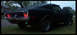 1968 Ford Mustang - The rear of a black coupe is shown with its taillights illuminated.