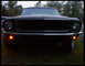 1968 Ford Mustang - Front view of a black 1968 Ford Mustang, showing its iconic grille and headlights.