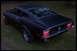 1968 Ford Mustang - The rear of a black 1967 Ford Mustang Fastback is shown with its distinctive triple taillights illuminated.