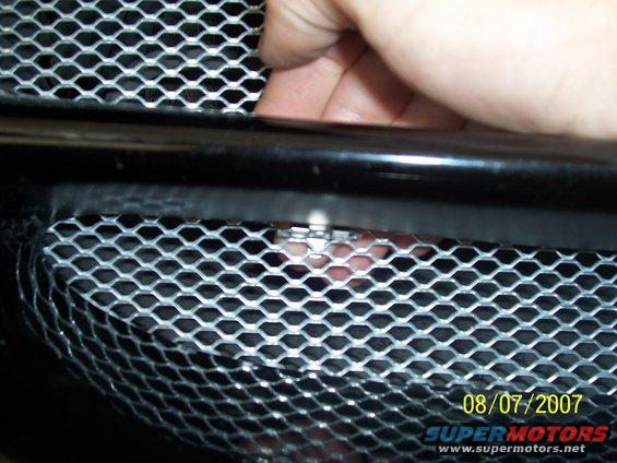 You can reach the top clip like so, careful the metal is sharp