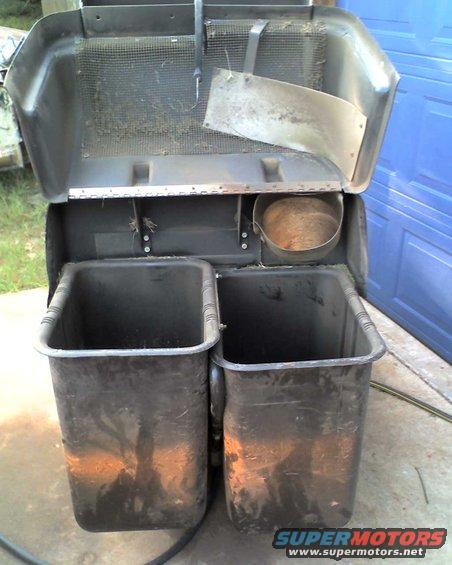 Lawn mower bagger with two black bins and metal chute