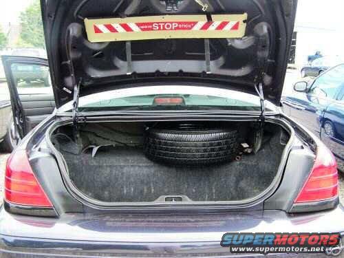 2003 Ford Crown Victoria trunk with spare tire and STOP sign
