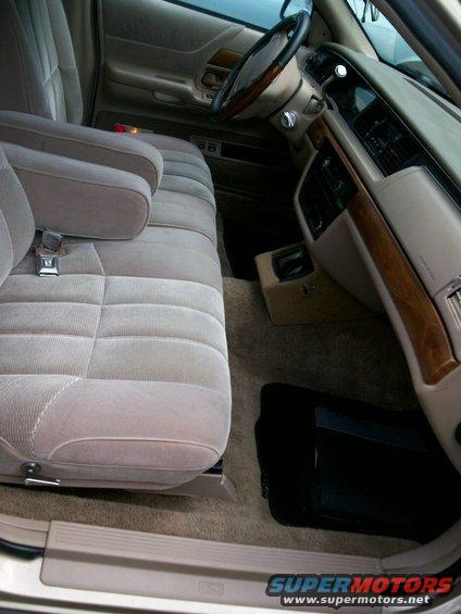 Tan fabric interior of a 1992 Ford Crown Victoria, showing front seats, dashboard, and steering wheel