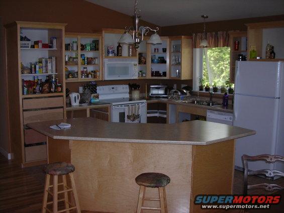 Kitchen interior with cabinets, appliances, and island