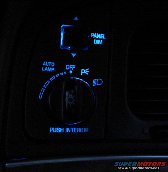 Interior light controls with blue backlighting: AUTO LAMP, OFF, PANEL DIM, and PUSH INTERIOR labels