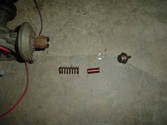 Distributor with spring, red sleeve, and washer on concrete