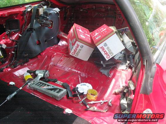 Interior of red car with tools and Gabriel Ultra G shock boxes