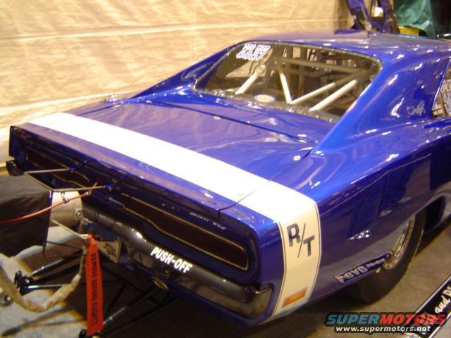 Blue drag car with white stripe and R/T decal on the side. Roll cage visible inside
