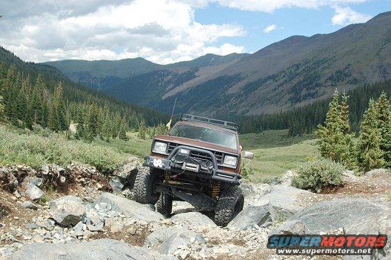 Brown 1986 Ford Bronco II off-roading on a rocky mountain trail