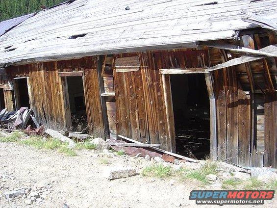 Dilapidated wooden building with weathered planks and holes in the roof