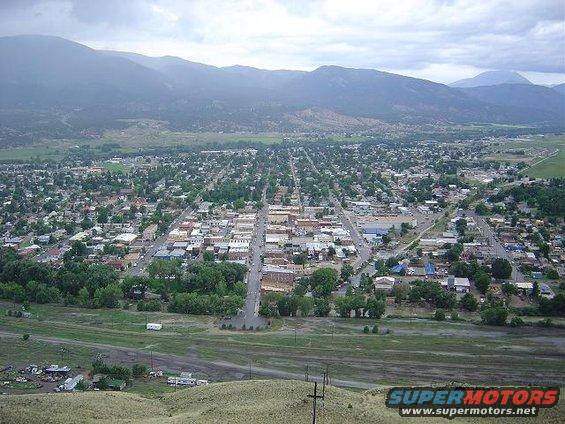 Aerial shot of a town with mountains in the background