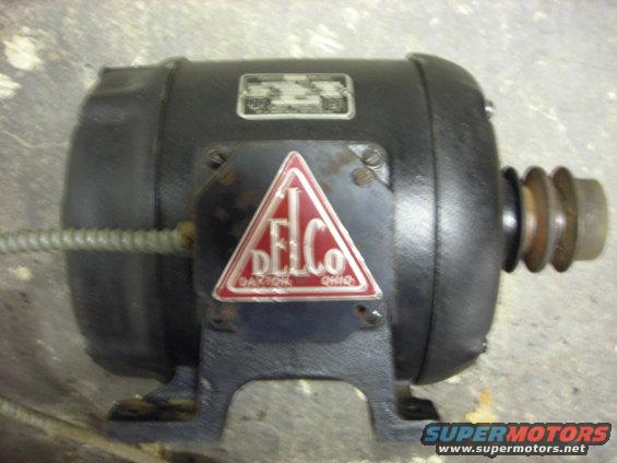 Black Delco electric motor with red triangle logo. Pulley on right end