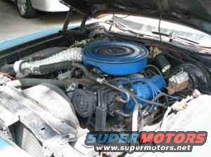 1973 Ford Ranchero engine bay with blue valve covers and a blue air cleaner assembly. The vehicle is light blue