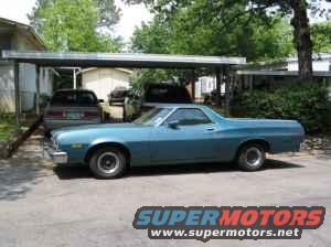 Blue 1973 Ford Ranchero parked under a carport, side view