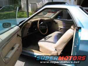 1973 Ford Ranchero interior, driver's side door open, showing tan seats and dashboard