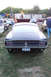 1968 Ford Mustang - Rear view of a dark 1968 Ford Mustang at an outdoor car gathering.