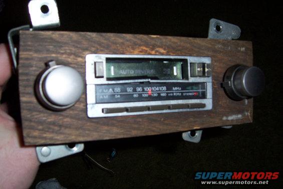 Car stereo with wood grain trim and 'AUTO REVERSAL' display