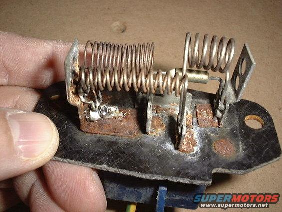 I drilled a 1/8in hole through the socket and added a wire. I soldered the wire to a piece of solid copper bus wire and lopped it around the base of the two resistor coils on the left. Then  soldered everything, kind of blobby, but its a good connection. 