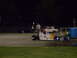 1991 Ford Mustang - A dragster with a patriotic theme sits on the track, with other vehicles visible in the background.