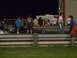 1991 Ford Mustang - Nighttime drag racing event with spectators and a race car on the track.