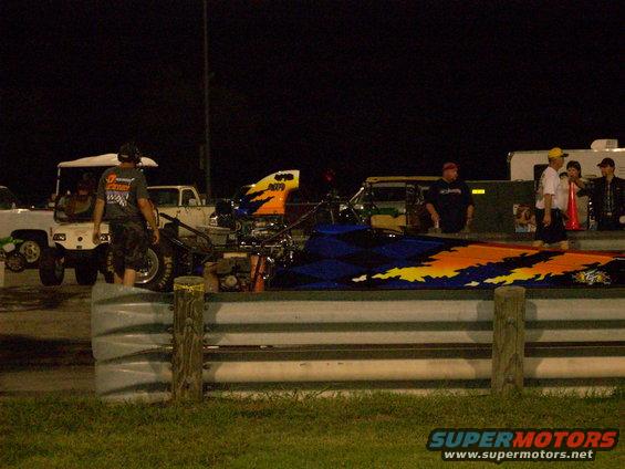Dragster with flame graphics on a track at night
