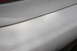 1992 Ford Taurus - Detail shot of a white vehicle's rear section, showing the bumper and a portion of the taillight.