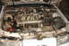 1992 Ford Taurus - The engine compartment of a car is shown with the hood raised, revealing the engine and associated parts.