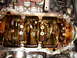 1992 Ford Taurus - Close-up view of an engine's internal components, showing the crankshaft and connecting rods coated in oil.