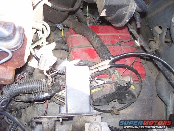 Close-up of engine bay wiring harness and red battery box
