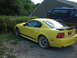2003 Ford Mustang - This yellow 2003 Ford Mustang coupe is seen parked in a driveway next to a dark SUV.