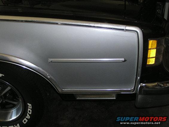 1973 Ford Ranchero front fender with silver two-tone paint, chrome trim, and amber turn signal