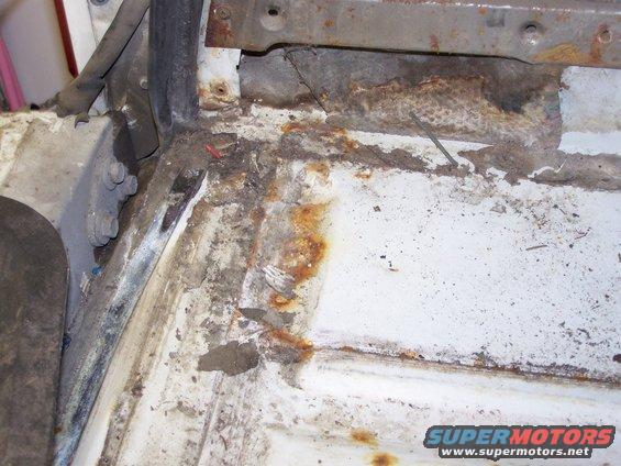 Rusted interior floor pan of a 1986 Ford Bronco