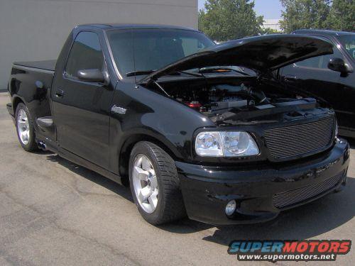 Black 1999 Ford F-150 SVT Lightning pickup truck, 3q front view, hood open