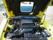 2003 Ford Mustang - The engine bay of a yellow 2003 Ford Mustang, viewed with the hood open.