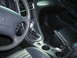 2003 Ford Mustang - Interior view of a 2003 Ford Mustang, highlighting the steering wheel and gear shifter.