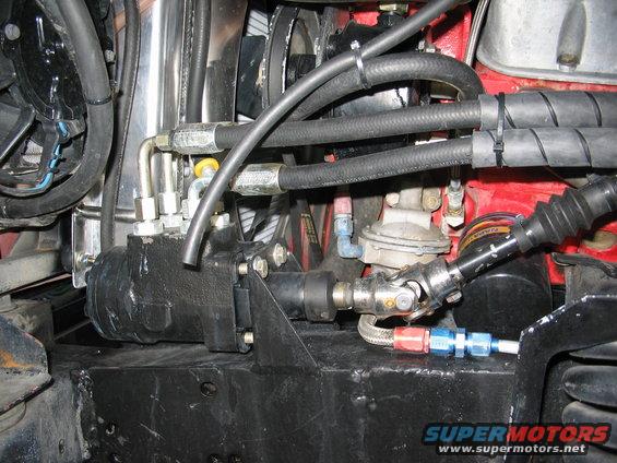 Close-up of vehicle power steering box and hoses