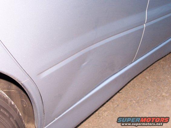 Silver car door with dent and side molding