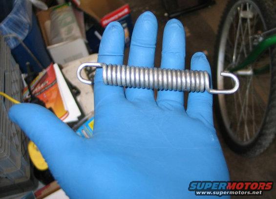 Let's say you have a strong spring.  (This is the centerstand spring from my 1975 CB750.)