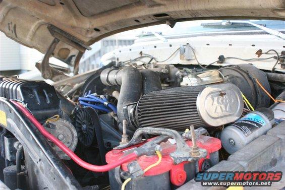 engine bay with K&N air filter, battery, and hoses visible