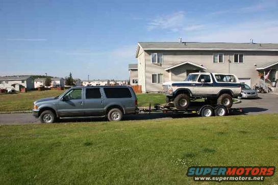 1978 Ford Bronco on trailer, white with blue stripe, 3q-front view